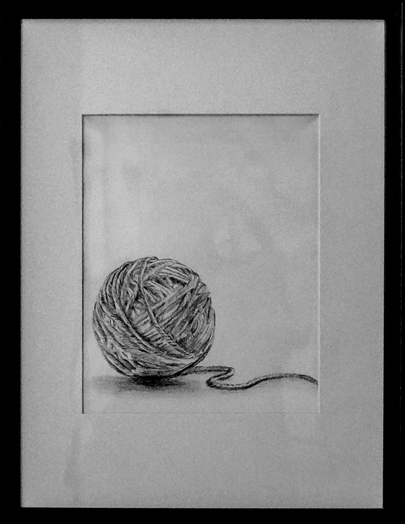 Framed pencil drawing of a ball of thread with a loose end